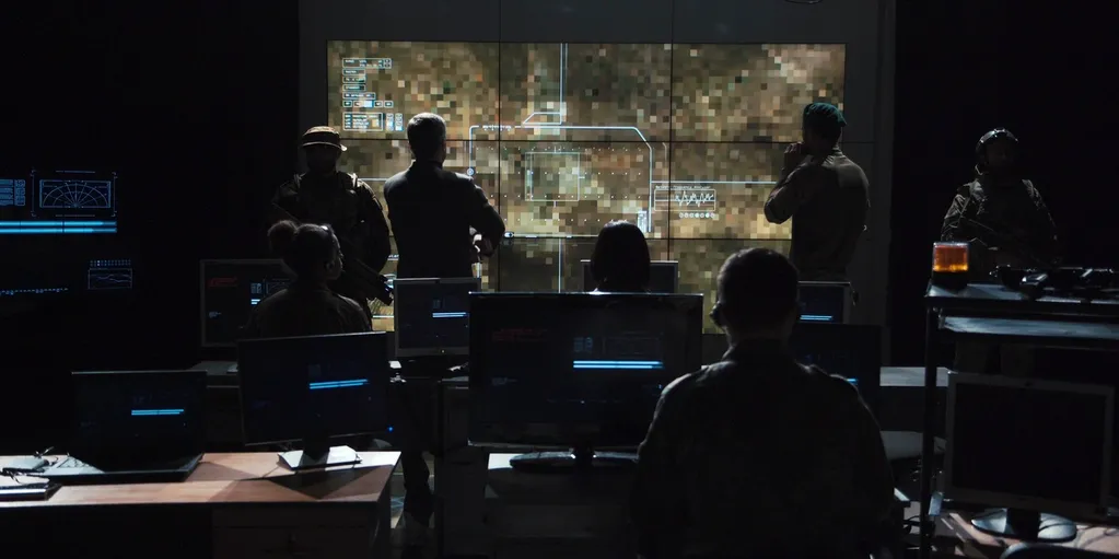 A Group of Tech Workers in Front of a Big Screen